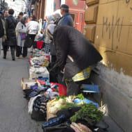 An elderly lady sells some produce at the market in Sarajevo