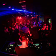 A club night at Trezor, viewed over ths shoulder of the DJ, with the dance floor filled with people