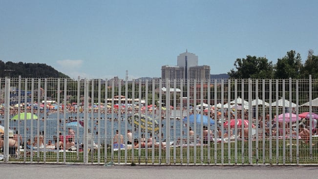 Panonsko jezero in Tuzla (a public lake for swimming), with the grass around the lake is packed with people